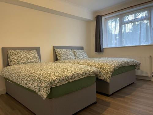 Un dormitorio con dos camas y una ventana. en Brighton Green Rose, en Brighton & Hove