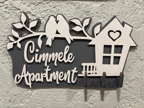 a house shaped sign hanging on a wall at Cimmele Apartment in Sigulda