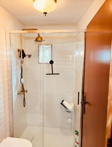 a bathroom with a shower and a toilet at Casa da Renda in Campos