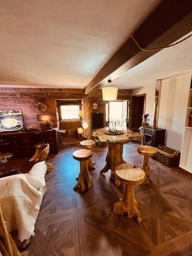 a living room with wooden tables and stools at Casa da Renda in Campos
