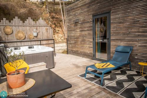 a patio with a blue chair and a table at La Parenthèse in Dieulefit