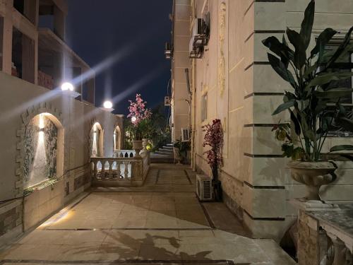 an alley with buildings and potted plants at night at modern villa with coverable pool sheik zayed in Sheikh Zayed