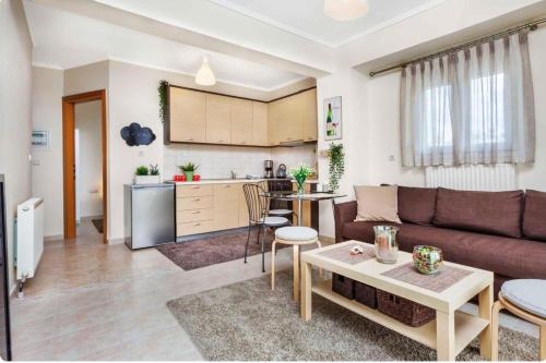 a living room with a couch and a table at #Ioanna Apartments Terminal Station Nikopoli in Thessaloniki