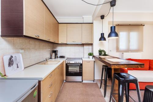 a kitchen with wooden cabinets and a counter top at #Ioanna Apartments Terminal Station Nikopoli in Thessaloniki