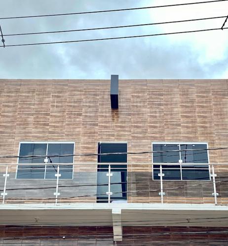 a brick building with windows on the side of it at Hospedaria Dona Santa in Pinheiro
