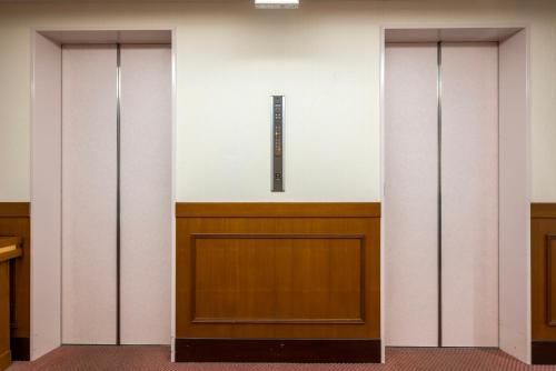 a row of elevators in a building at Taira View Hotel in Iwaki