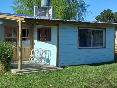 a house with a deck with chairs on it at Cabañas Virazón - Las chircas in San Eduardo del Mar
