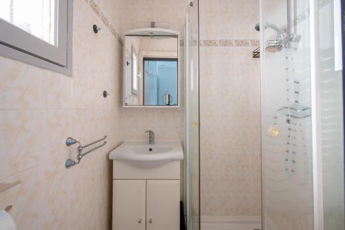 une salle de bain avec un lavabo et une douche dans l'établissement L'Esprit Bohème - Terrasse - Proche camp naturiste, au Cap d'Agde