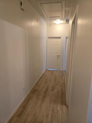 an empty hallway of an apartment with a door at Fresh Crash Pads 4 in Houston