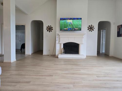 a living room with a fireplace with a tv above it at Fresh Crash Pads 4 in Houston