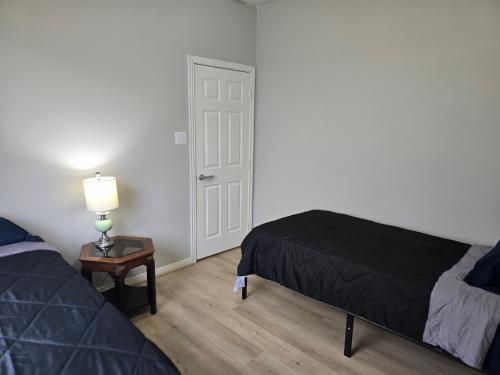 a bedroom with a bed and a table with a lamp at Fresh Crash Pads 4 in Houston