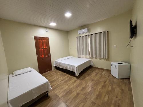 Postel nebo postele na pokoji v ubytování Vila Suítes