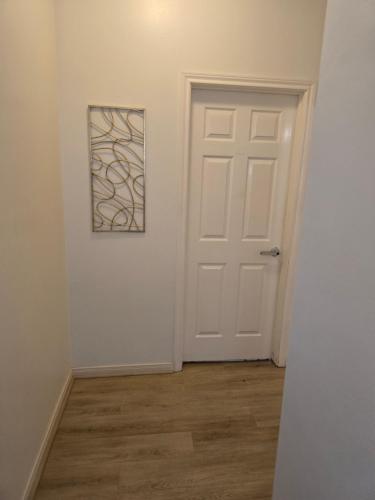 a room with a door and a picture on the wall at Fresh Crash Pads 4 in Houston