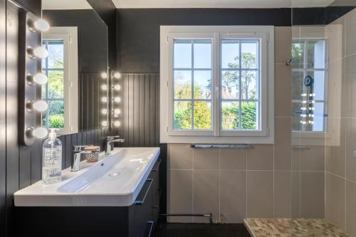 a bathroom with a sink and a window at Magnifique maison basque avec piscine 8 pers- Biarritz in Biarritz