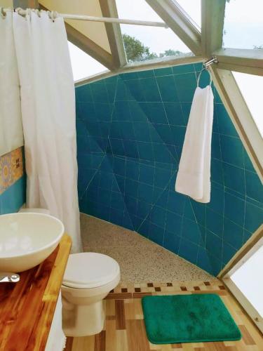 a bathroom with a toilet and a sink at Eco Domo glamping in Armenia