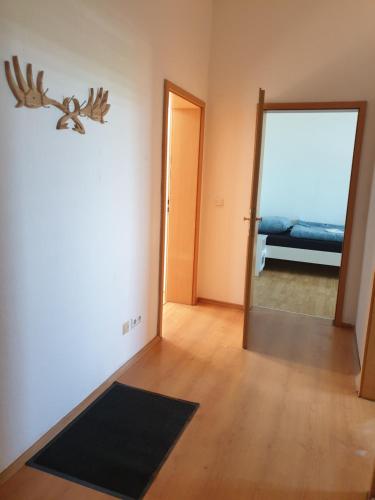 an empty room with a door and a mirror at Monteurwohnung bei Nina 2OGR in Zeitz