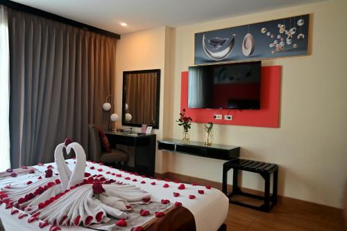 Ένα ή περισσότερα κρεβάτια σε δωμάτιο στο Boss Suites Nana Hotel