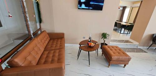 a living room with a couch and a table at Къща за гости ЕСТЕТ ESTET Guest house in Oreshak