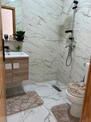 a bathroom with a toilet and a sink at villa lux in Kenitra