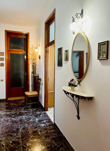 a hallway with a mirror and a table with a mirror at 2-bedroom apartment ILLARIO - heart of Tuscany - airco & free parking in Pomarance
