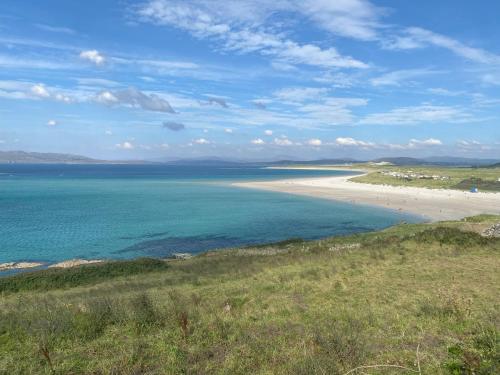 a view of a beach with people in the water at Waterstone, Narin Portnoo in Portnoo