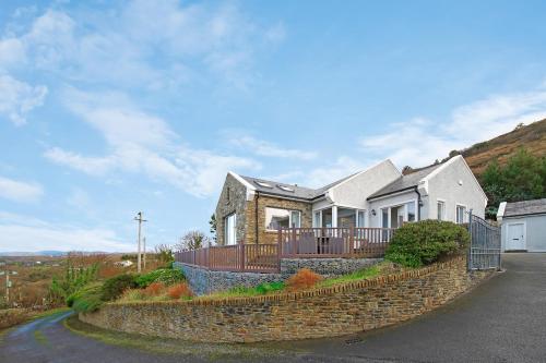 a house on a hill with a stone wall at Waterstone, Narin Portnoo in Portnoo
