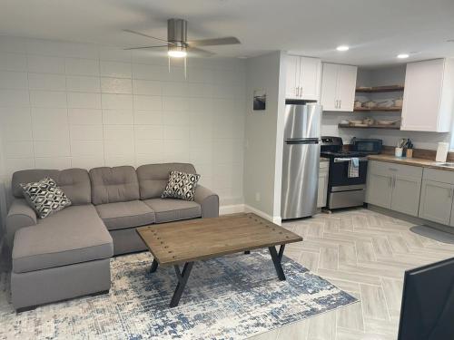 a living room with a couch and a table in a kitchen at Warm Waters Escape in North Port