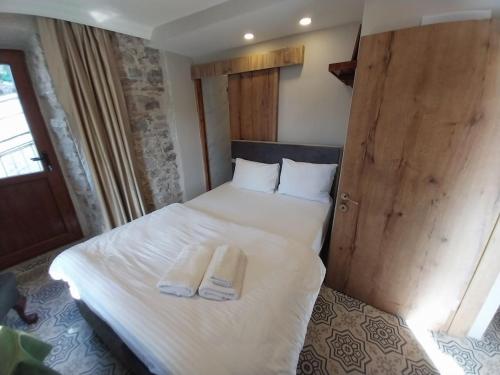 a bedroom with a bed with two towels on it at Yeşiltepe Budget in Konak