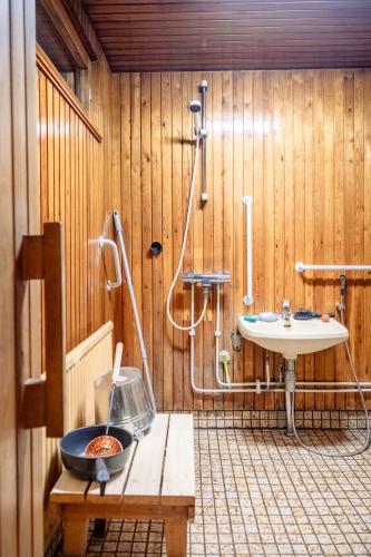 a bathroom with a sink and a shower and a toilet at Villa Blue in Autti