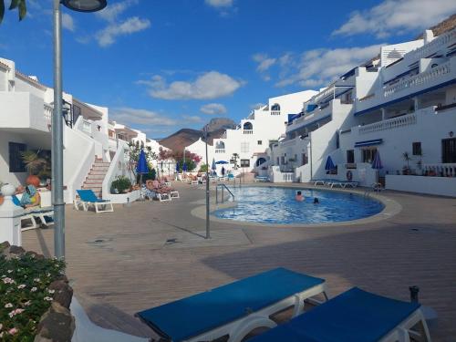 a swimming pool in the middle of a building at Best4Buck in Los Cristianos