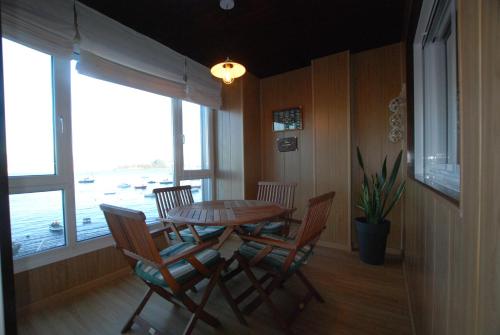 a dining room with a table and four chairs at M O A Apartamento mariñeiro in Baiona