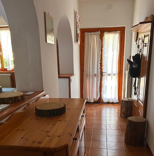 a living room with a wooden table and two stools at Good Stay Borno in Borno