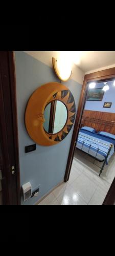 a mirror on the wall of a room with a bed at Casa Elena b&b in Naples