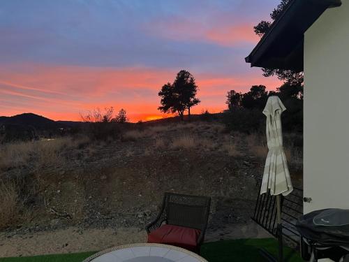 a sunset from a patio with a table and chairs at Sweet Hill top Townhouse in Prescott