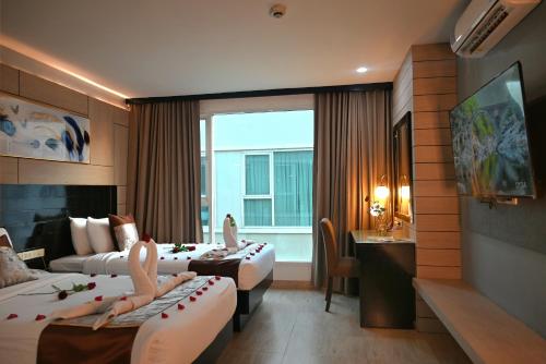 Ένα ή περισσότερα κρεβάτια σε δωμάτιο στο Boss Suites Nana Hotel