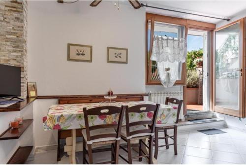 a dining room with a table and chairs and a window at Poggio dei Carli in Marcialla