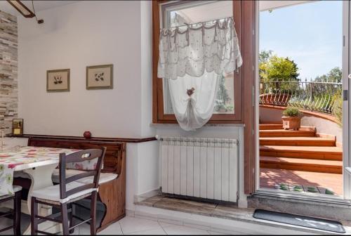 a dining room with a table and a window at Poggio dei Carli in Marcialla