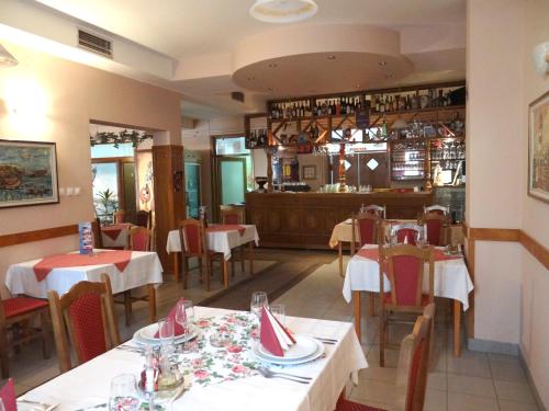 a restaurant with tables and chairs and a bar at Naša Tvrđava Guest Accommodation in Novi Sad