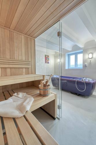 a sauna with a blue tub in a room at AnnaVila in Piešťany