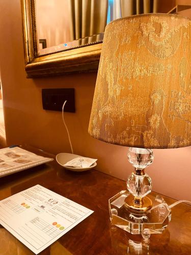 a lamp sitting on a table in a room at Pensione Accademia - Villa Maravege in Venice