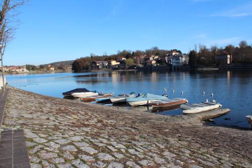 a group of boats are docked on a lake at Like Home mono 2 in Sesto Calende