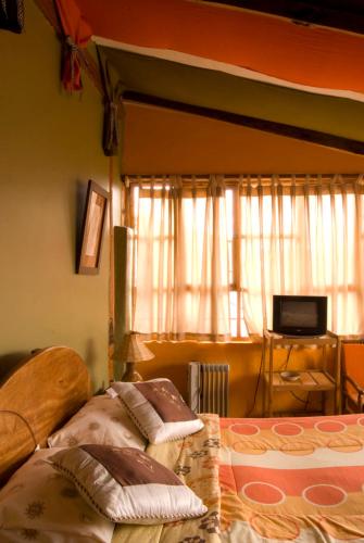 a bedroom with two beds and a window at Casa De Mama Cusco - The Treehouse in Cusco