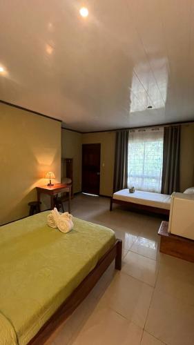 a large bedroom with a bed and a window at Cabinas Villa Drake in Drake