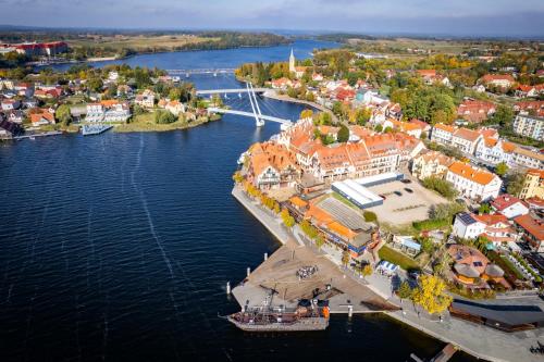 an aerial view of a town next to a river at Avanti Resort Mikołajki , w centrum przy jeziorze i promenadzie, śniadanie , obiad lub obiadokolacja in Mikołajki