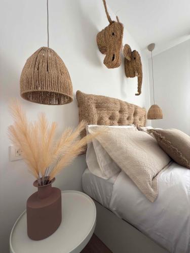 a bedroom with a bed with pillows and a table at Apartamento La Gata del Cabo in El Cabo de Gata