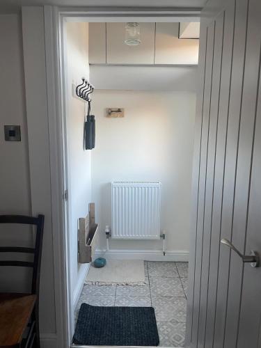 a hallway with a door leading into a room at Willden Cottage in Holmfirth