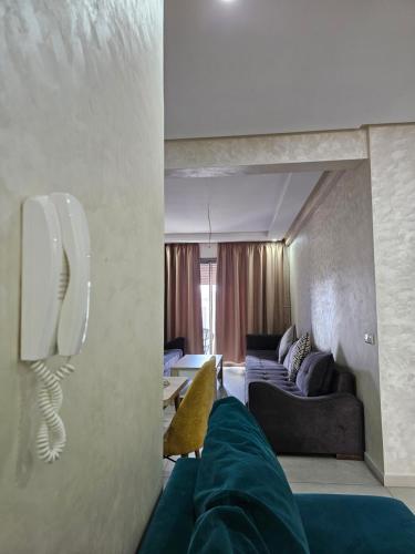a living room with a couch and a phone on the wall at Appartement Résidence F3 in Essaouira
