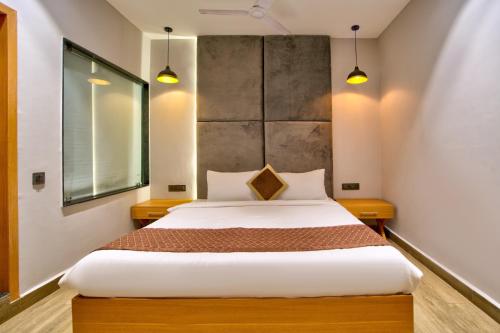 a bedroom with a large bed in a room at The Beach House Candolim in Candolim