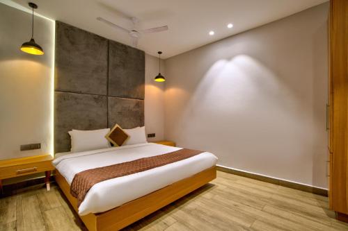 a bedroom with a large bed in a room at The Beach House Candolim in Candolim