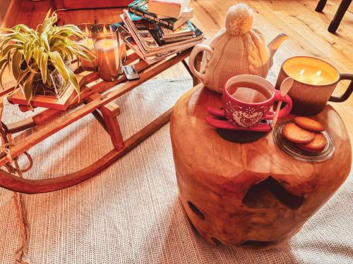 a table with a tea pot and a cup of coffee at La Cabane de Marie in La Bollène-Vésubie
